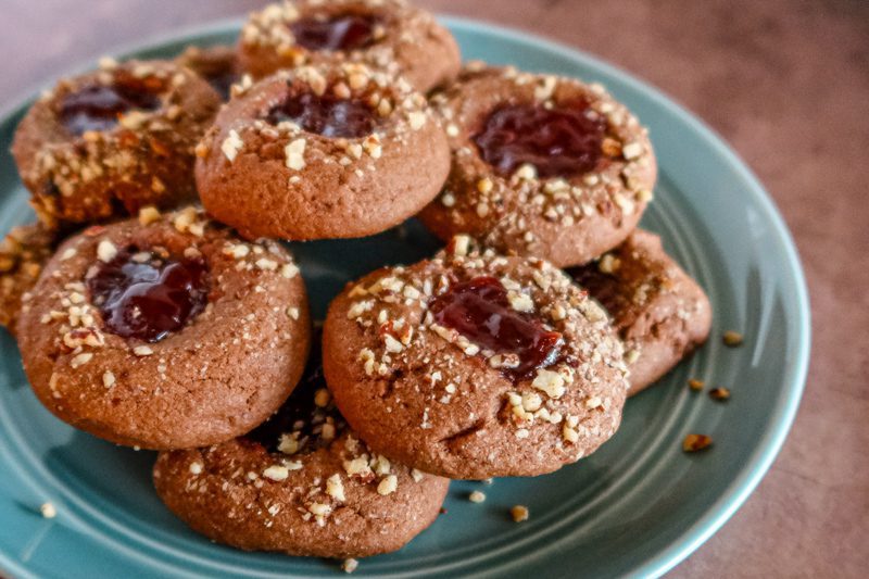 Closeup of chocolate raspberry thumbprint cookies