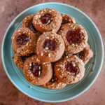 chocolate raspberry thumbprint cookies on a plate