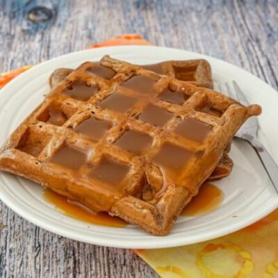 chocolate waffles on a plate with golden syrup