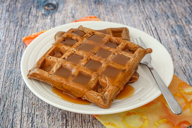 chocolate waffles on a plate with golden syrup