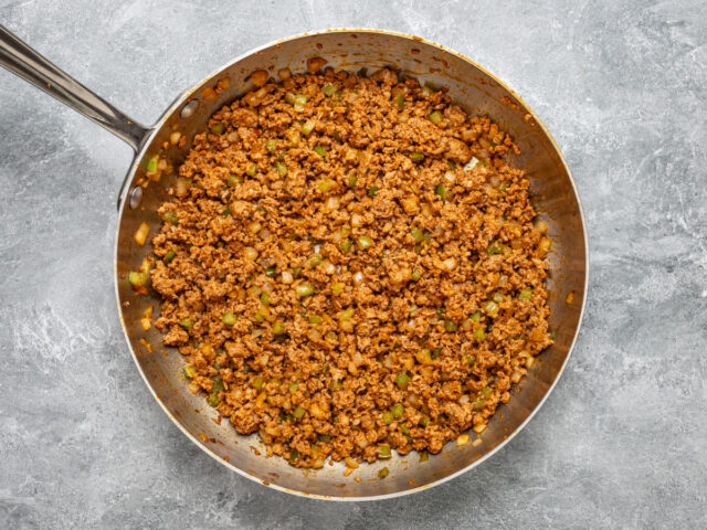 A skillet with chorizo sausage for making spicy quiche squares.