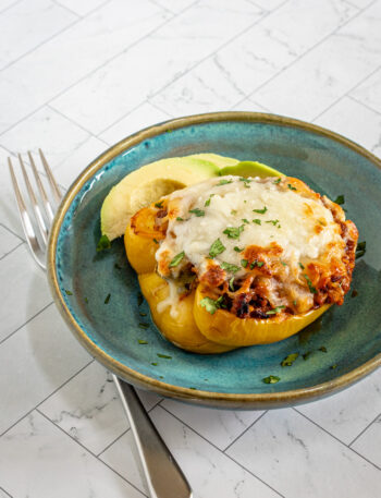 Chorizo stuffed peppers with cheese topping.