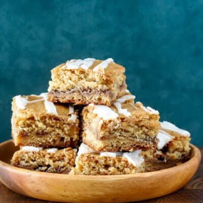 A stack of cinnamon roll blondies, cut to show the lovely cinnamon swirls.