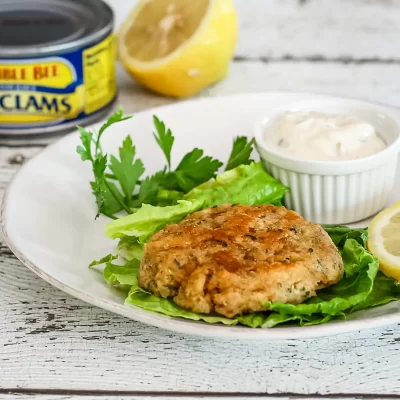 Crispy fish fillet on a bed of lettuce with lemon and tartar sauce.