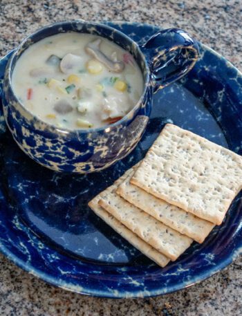 clam and corn chowder with crackers on the side