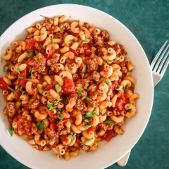 Savory pasta with ground beef, tomatoes, and fresh herbs.