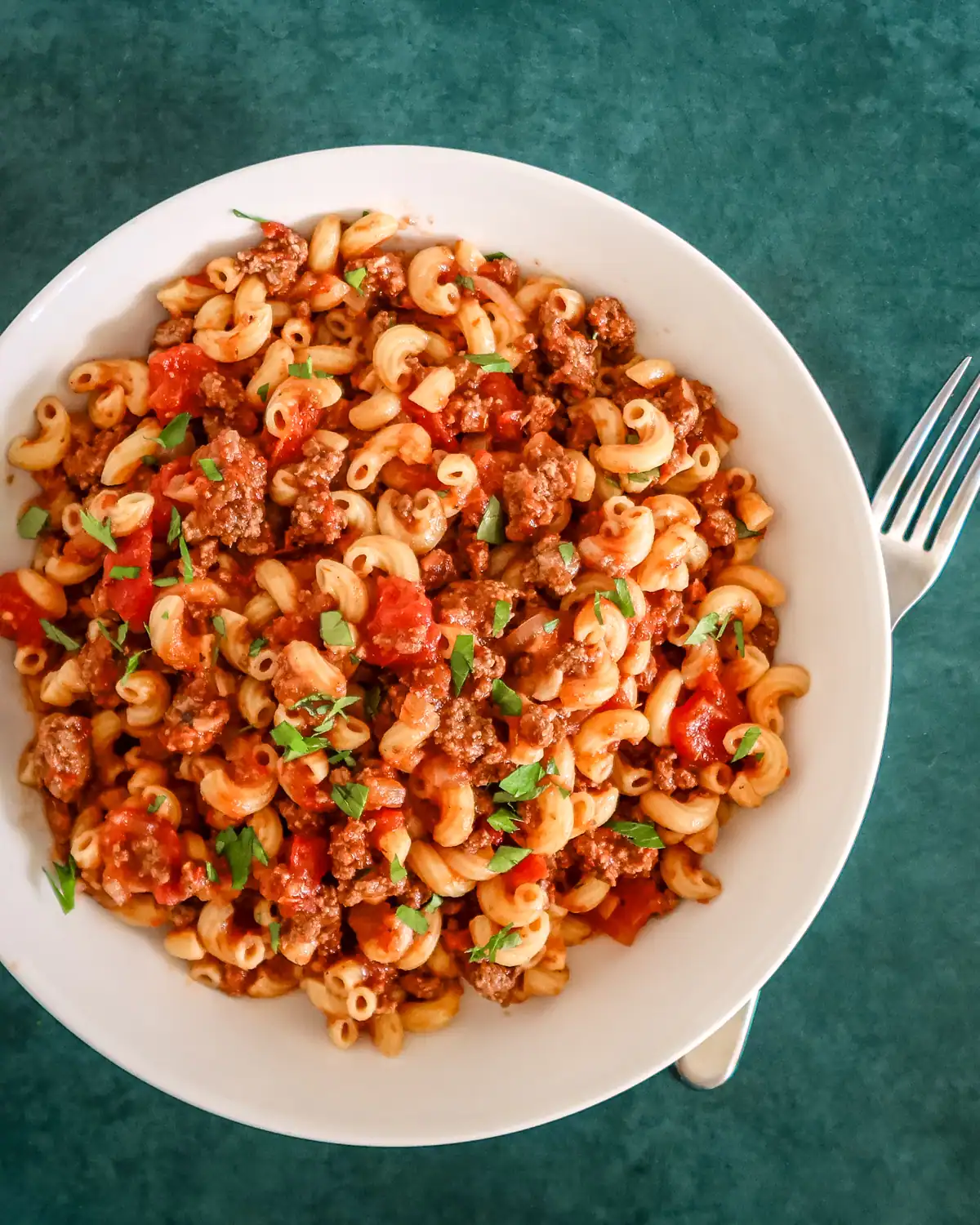 Savory pasta with ground beef, tomatoes, and fresh herbs.
