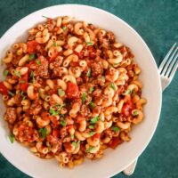 Classic American chop suey in a wide bowl with parsley garnish.