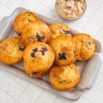 moist blueberry muffins with whipped cinnamon butter on the side