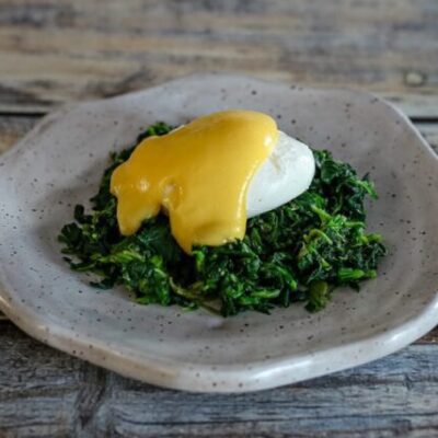 classic hollandaise sauce on a poached egg