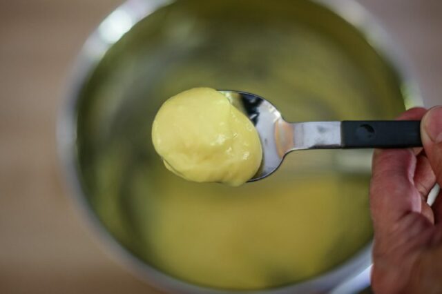 rich hollandaise sauce on a spoon