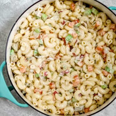 A creamy, flavorful macaroni salad in a Dansk pot for serving.