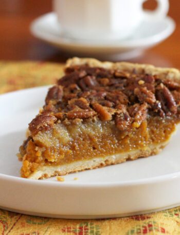 A classic pumpkin pecan pie on a dessert plate