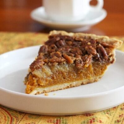 A classic pumpkin pecan pie on a dessert plate