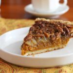 a slice of pumpkin pecan pie on a plate