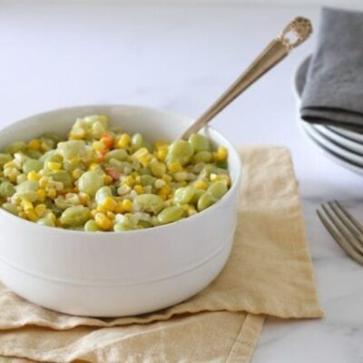 a serving bowl of succotash with corn and lima beans