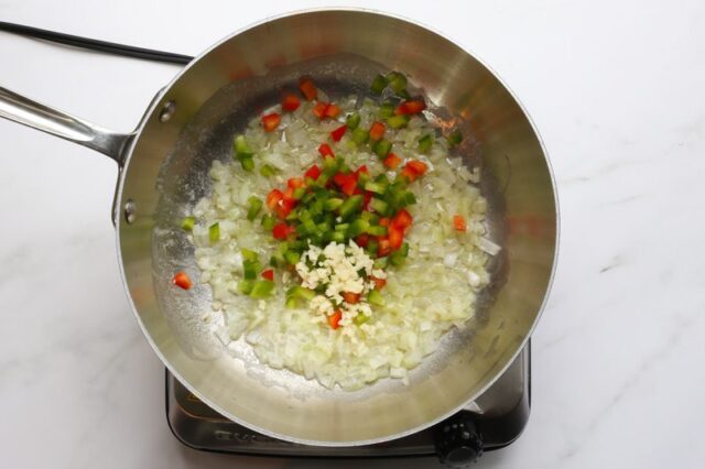 sautéing bell peppers, garlic, and onions for colorful succotash