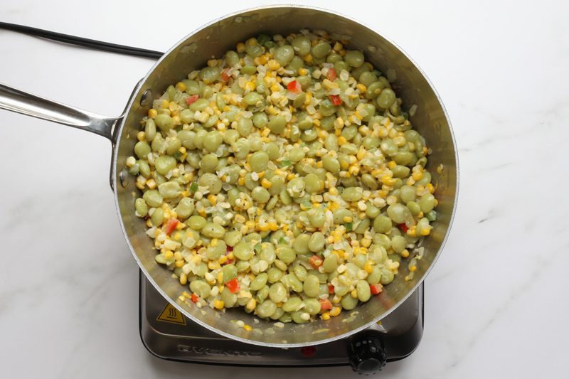 southern succotash cooking in a saucier pan
