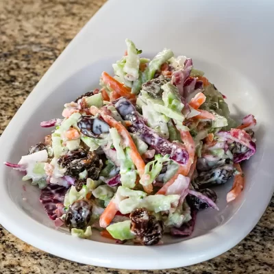Creamy mixed vegetable salad with carrots, cabbage, and purple cabbage.