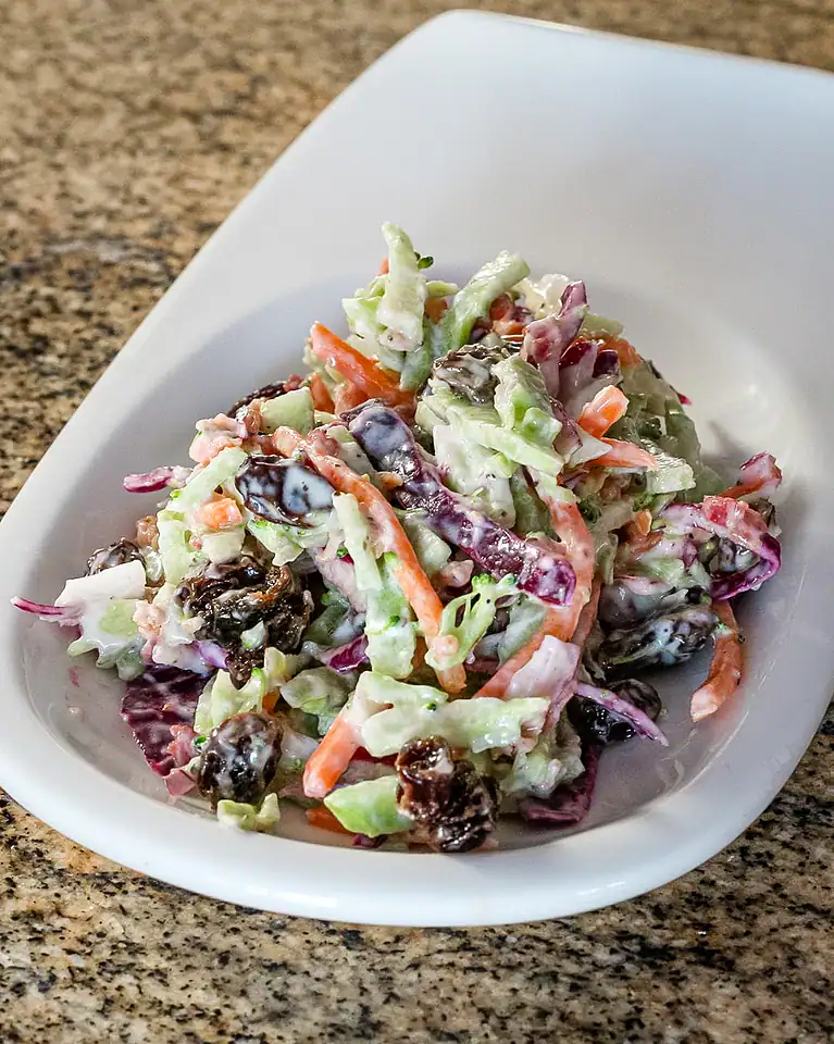 Creamy mixed vegetable salad with carrots, cabbage, and purple cabbage.