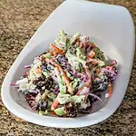 Creamy mixed vegetable salad garnished with dark sauce dressing.