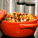 corn and black bean salad in an orange bowl