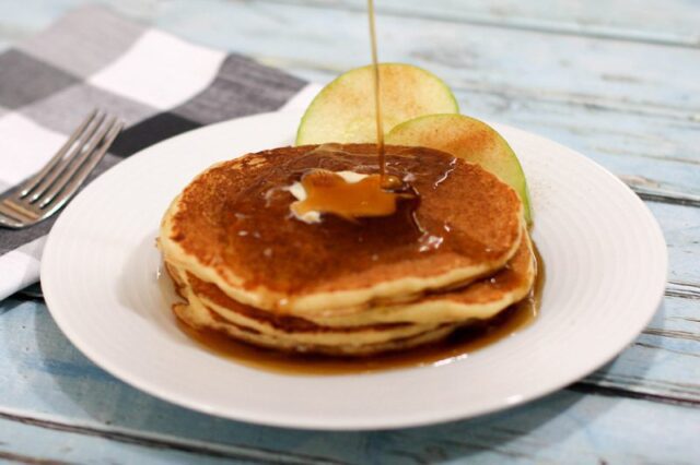 syrup is poured over the cornmeal pancakes