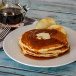 cornmeal buttermilk pancakes with butter and syrup