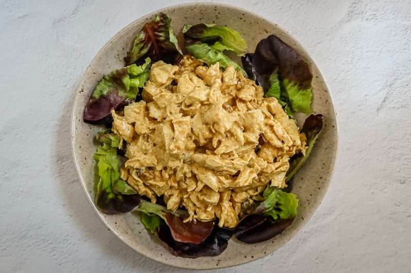 a serving bowl with classic british coronation chicken