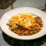 serving of cottage pie with cheese topping