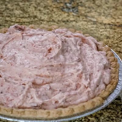 Creamy strawberry pie filling in a homemade crust.