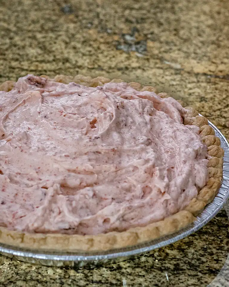 Creamy strawberry pie filling in a homemade crust.