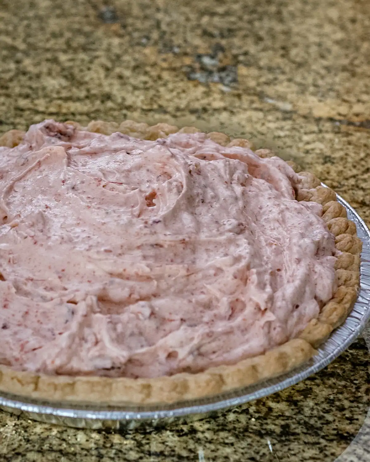 Creamy strawberry pie filling in a homemade crust.