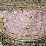 Creamy strawberry pie filling in a pie crust.