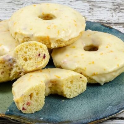 baked cranberry orange donuts on a plate