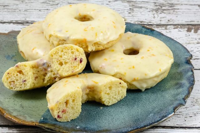 baked cranberry orange donuts on a plate