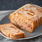a loaf of easy cranberry bread, glazed with orange icing