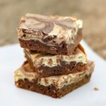 chocolate and cream cheese swirl brownies in a stack