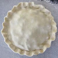 Dough in a pie crust shell ready for filling.