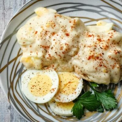 creamed eggs on biscuits with sliced eggs on the side