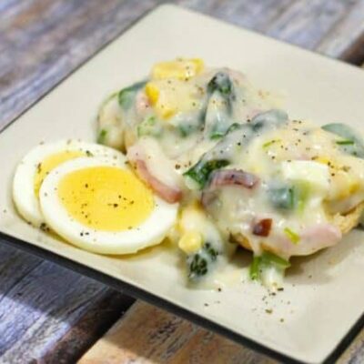 creamed ham and asparagus with hard boiled eggs on a plate