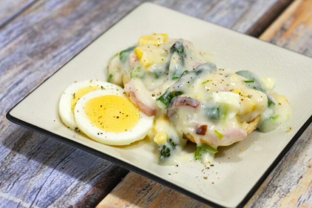 creamed ham and asparagus with hard boiled eggs on a plate