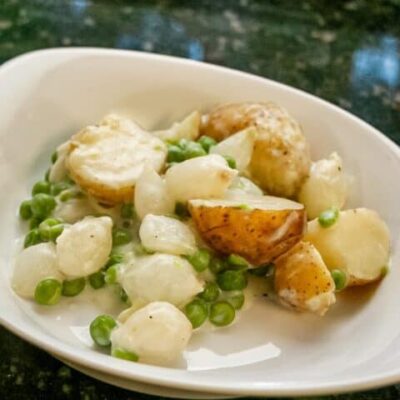 creamed new potatoes with peas and onions