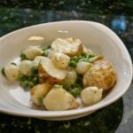 creamed new potatoes with peas and boiling onions