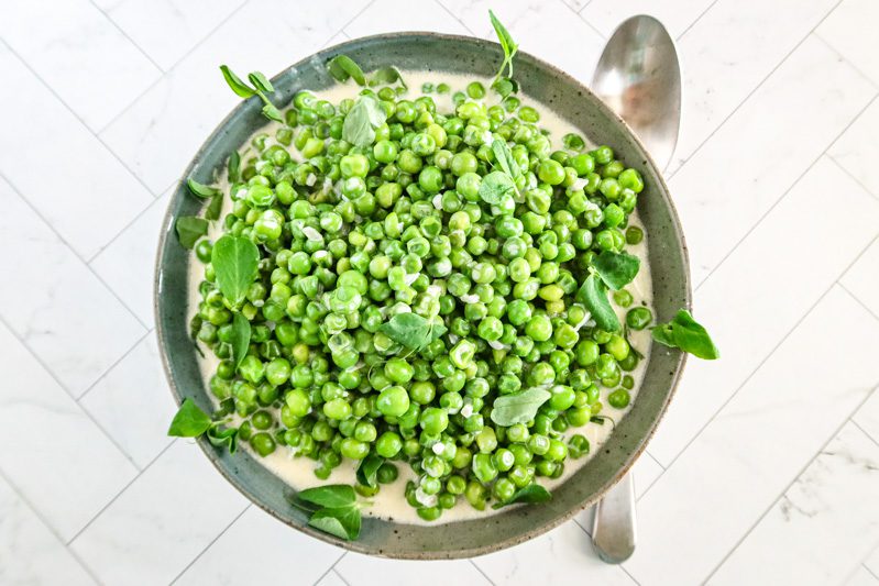 creamed peas with pea shoots in a bowl