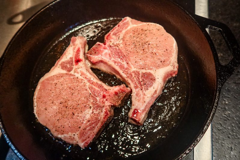 pork chops in an iron skillet