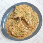 creamy apple cider pork chops with chives garnish