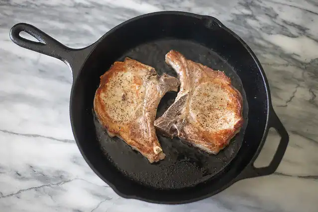Apple cider pork chops prep: searing the chops.
