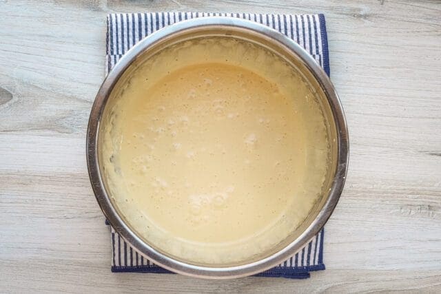Creamy, frothy batter in a metal bowl.