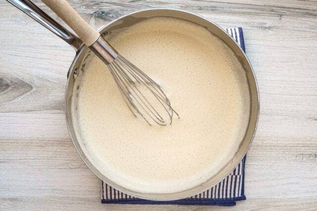 Crème anglaise prep: Cooking the sauce until thick and rich.